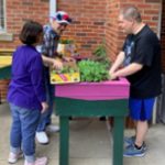 participants in adult day care pot plants together